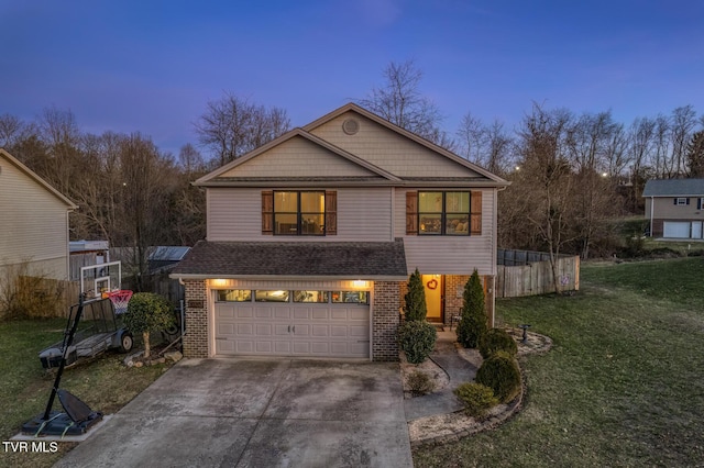 front of property with a garage and a yard