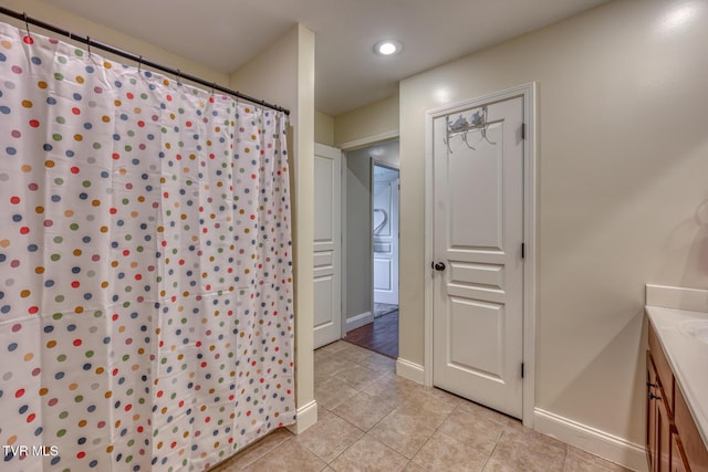 bathroom with tile patterned flooring and vanity