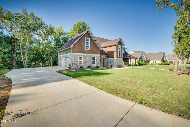 craftsman-style house with a front yard, stone siding, driveway, and an attached garage