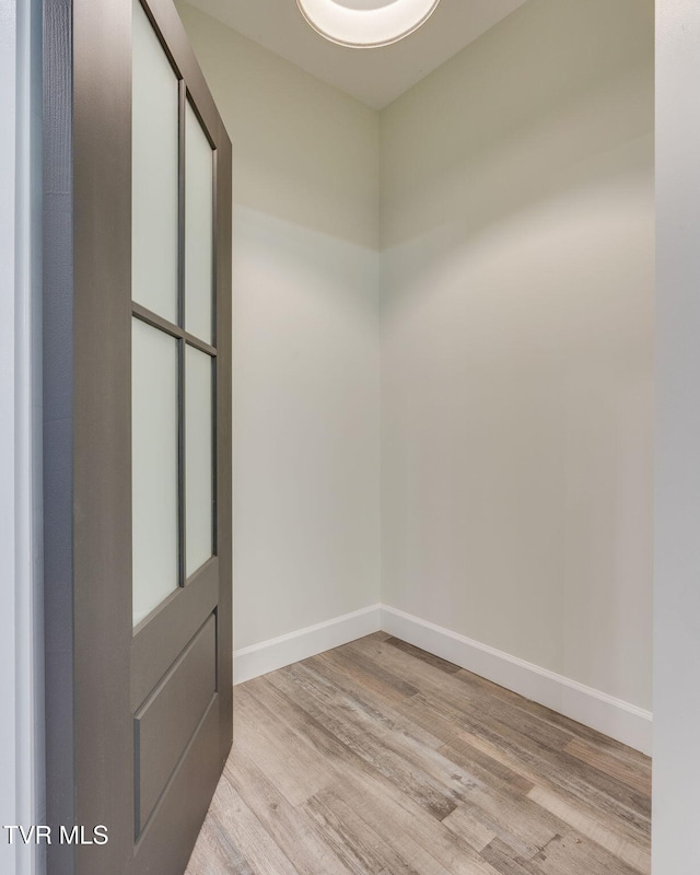 spare room with light wood-type flooring and baseboards