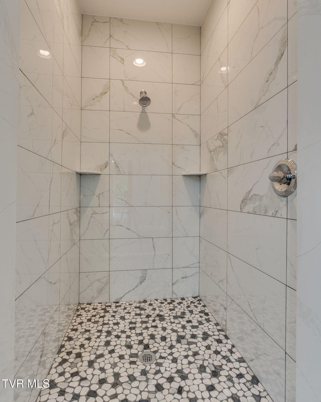 full bath with a tile shower