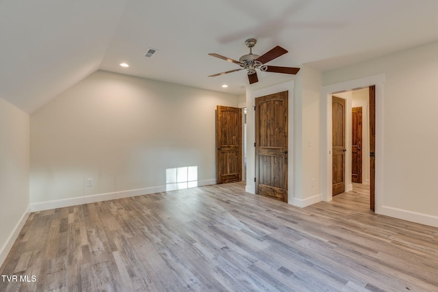 unfurnished bedroom featuring light wood-style flooring, recessed lighting, a ceiling fan, baseboards, and vaulted ceiling