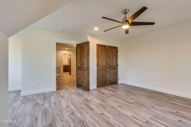 unfurnished bedroom with a ceiling fan, light wood-type flooring, a closet, and baseboards