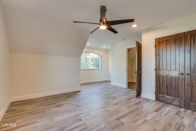 additional living space featuring recessed lighting, a ceiling fan, baseboards, vaulted ceiling, and light wood-style floors