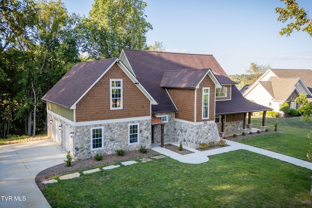 view of front facade with a garage, a front yard, and concrete driveway