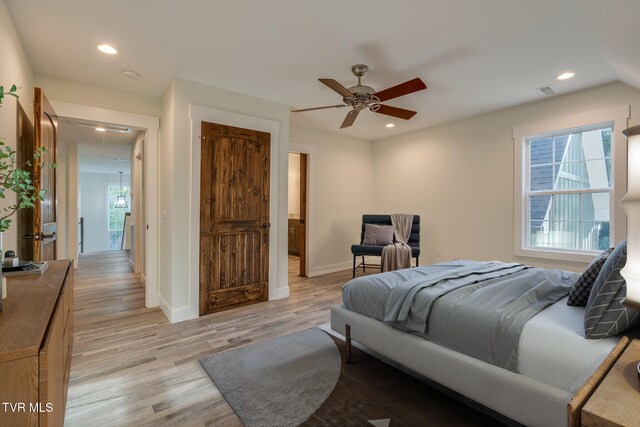 bedroom featuring light wood-type flooring, attic access, baseboards, and recessed lighting