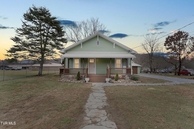 bungalow-style home featuring a yard and a porch