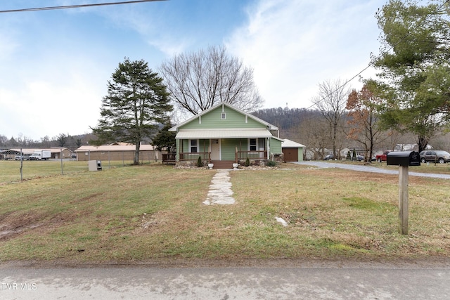 view of front of home featuring covered porch and a front yard