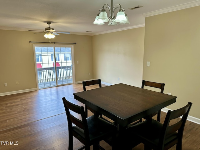 dining room with hardwood / wood-style floors, crown molding, and ceiling fan with notable chandelier