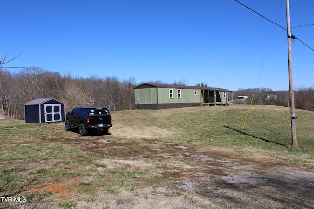 view of yard with an outdoor structure and a storage unit