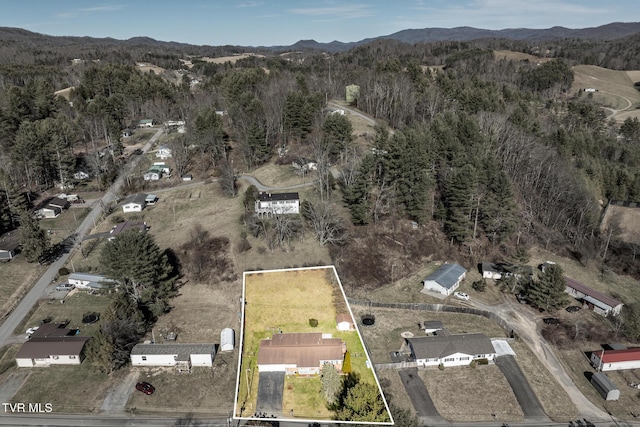 bird's eye view with a forest view and a mountain view