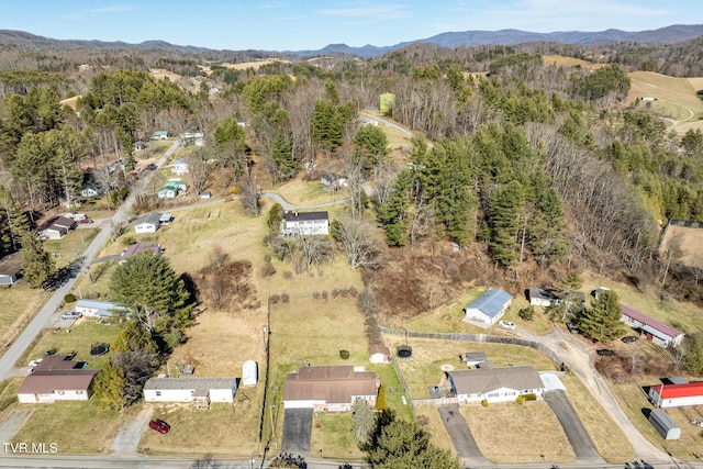 aerial view featuring a mountain view and a view of trees