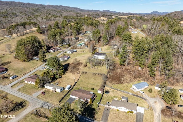 drone / aerial view with a mountain view and a wooded view