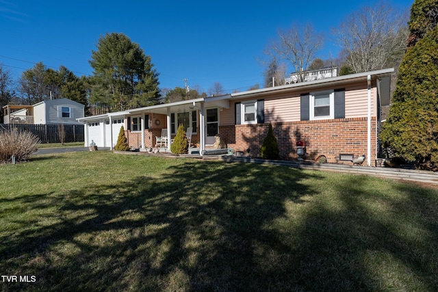 single story home with an attached garage, fence, a front lawn, a porch, and brick siding