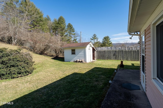 view of yard with an outbuilding, fence, and a shed