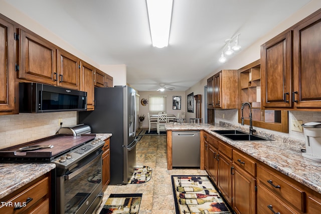 kitchen with stainless steel appliances, a sink, decorative backsplash, and open shelves