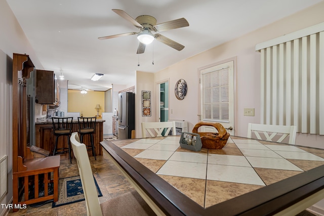 dining space featuring ceiling fan