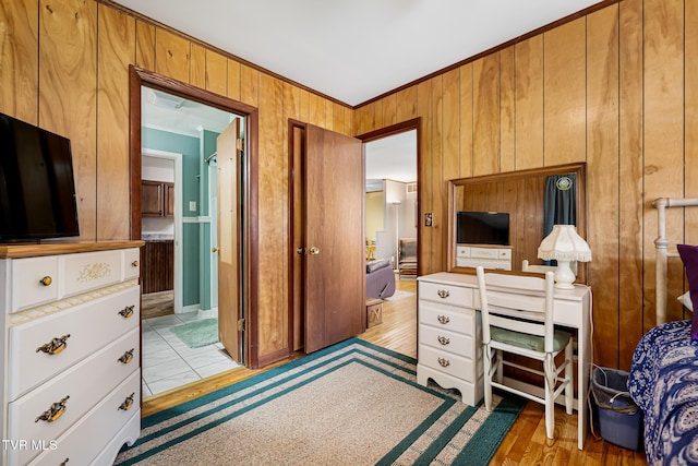 office area featuring light wood finished floors, ornamental molding, and wooden walls