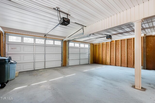 garage with metal wall and a garage door opener