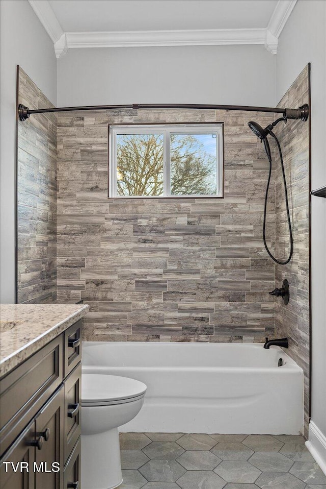 full bathroom featuring tiled shower / bath combo, crown molding, vanity, and toilet