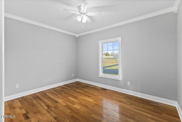 spare room featuring ornamental molding, dark wood-type flooring, and ceiling fan