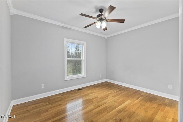 empty room with crown molding, wood-type flooring, and ceiling fan