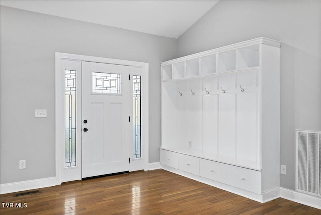 interior space featuring vaulted ceiling and dark hardwood / wood-style flooring