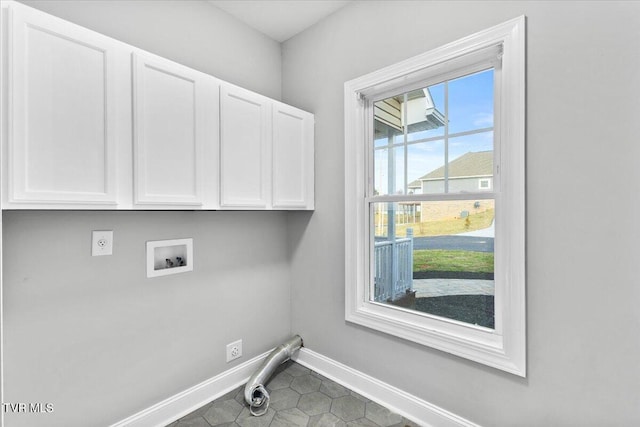 laundry room with cabinets, electric dryer hookup, hookup for a washing machine, and tile patterned floors