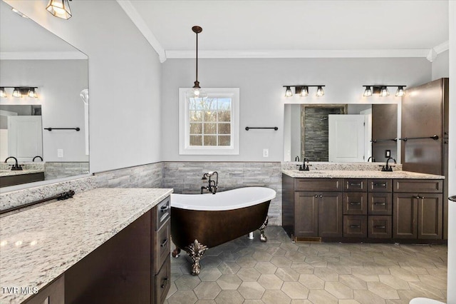 bathroom featuring ornamental molding, tile walls, and vanity