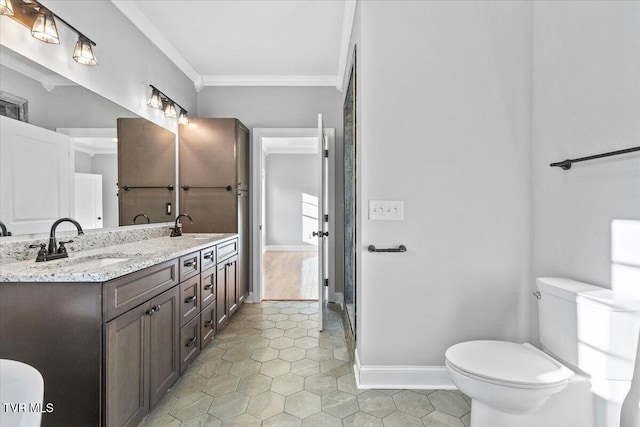 bathroom with crown molding, vanity, tile patterned floors, and toilet