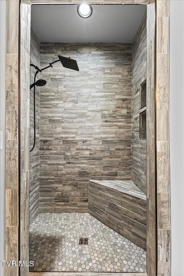 bathroom with a tile shower