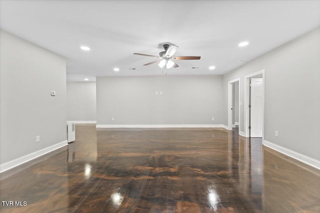 empty room featuring radiator heating unit and ceiling fan