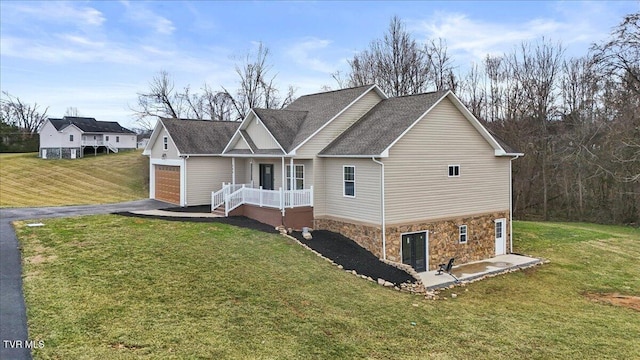 rear view of house with a garage and a yard