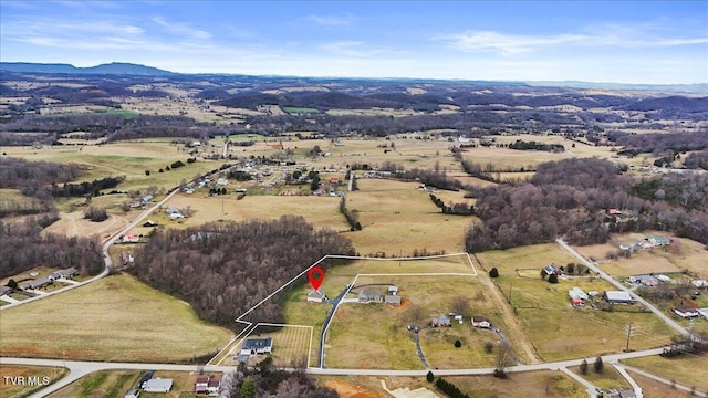 birds eye view of property with a rural view