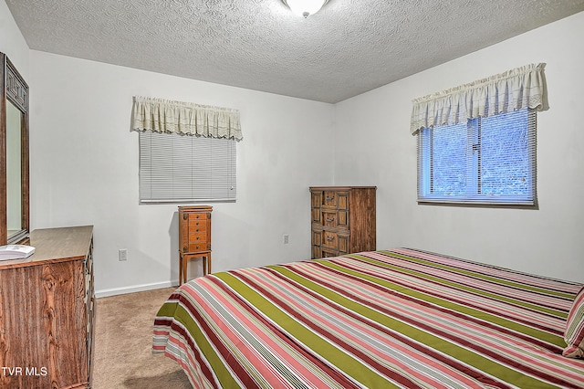 bedroom with light carpet and a textured ceiling