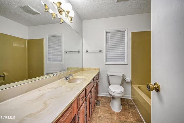 bathroom featuring vanity, a textured ceiling, tile patterned floors, and toilet