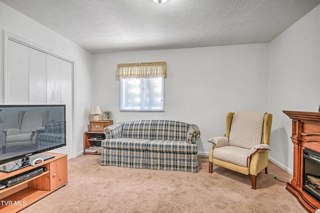 carpeted living room with a textured ceiling