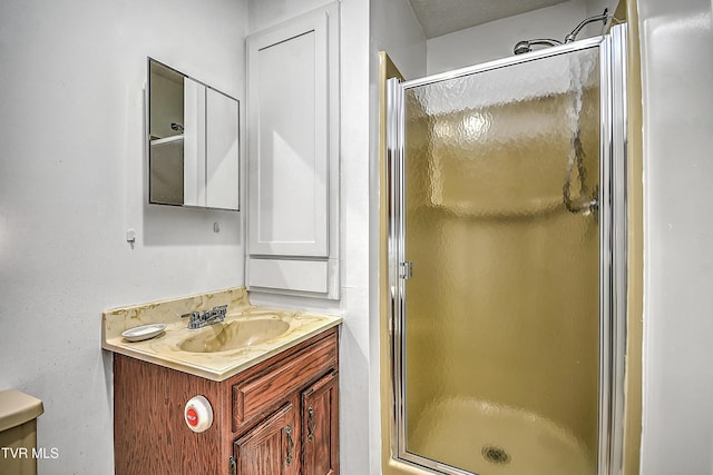 bathroom featuring vanity and a shower with shower door