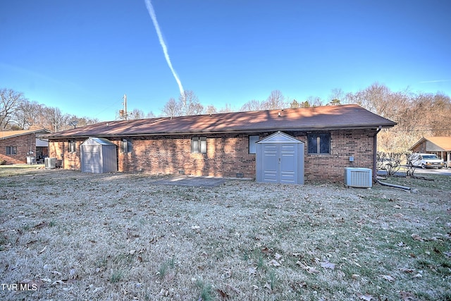 exterior space with central AC, a shed, and a front yard