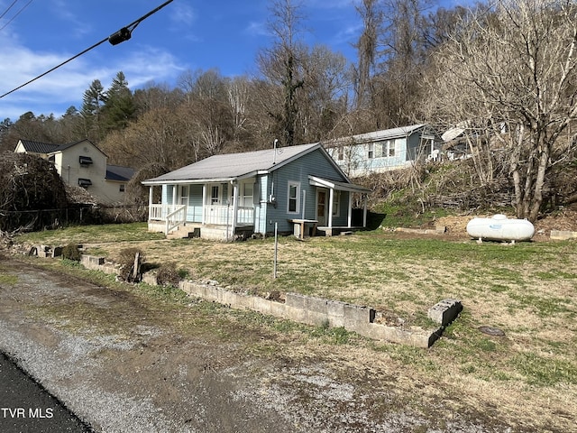 view of front of home featuring a front yard and a porch