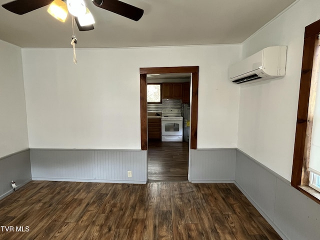 spare room featuring ceiling fan, dark hardwood / wood-style floors, and a wall mounted AC