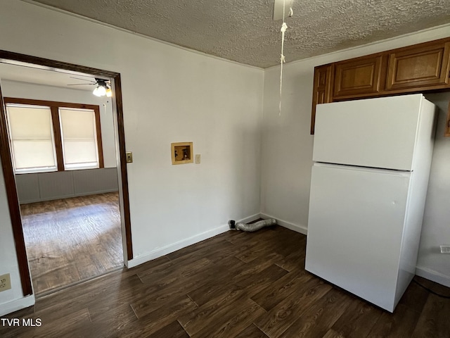 interior space with washer hookup, a textured ceiling, dark wood-type flooring, and ceiling fan