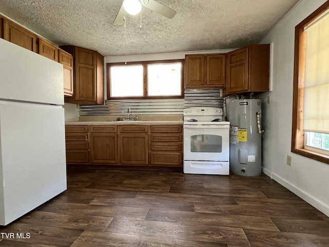 kitchen with sink, white appliances, dark wood-type flooring, water heater, and a textured ceiling