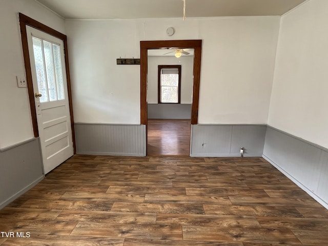 unfurnished room featuring dark hardwood / wood-style floors and ceiling fan