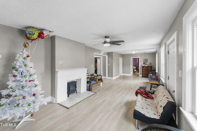 living room with ceiling fan and light hardwood / wood-style flooring