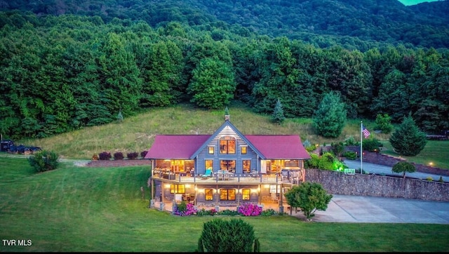 exterior space featuring a lawn and a deck