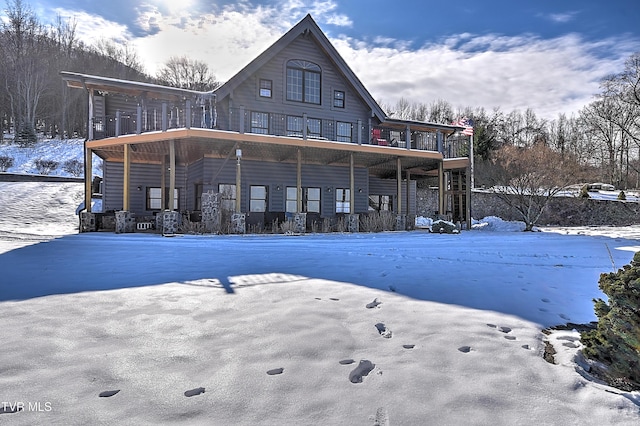 view of snow covered rear of property