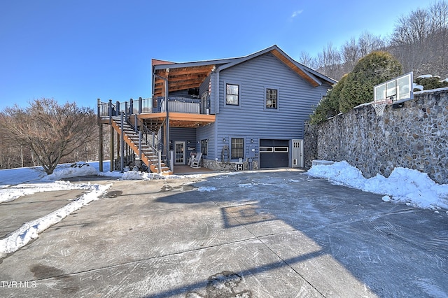 exterior space with a wooden deck and a garage