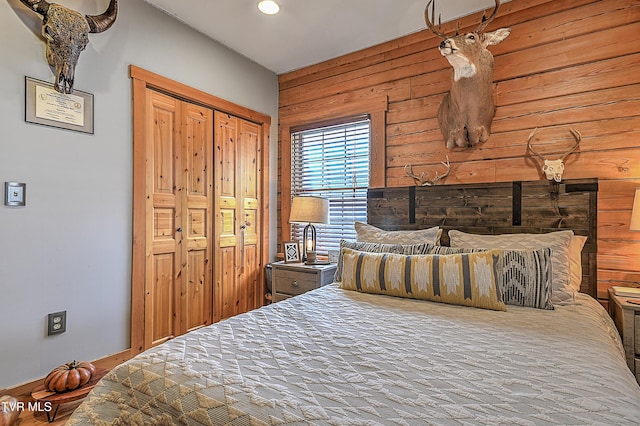 bedroom featuring wood walls