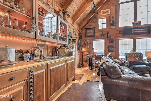 kitchen featuring light hardwood / wood-style flooring, backsplash, beam ceiling, high vaulted ceiling, and wooden ceiling